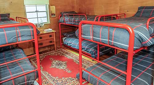 Six bunk-style beds in the Settlers Hut