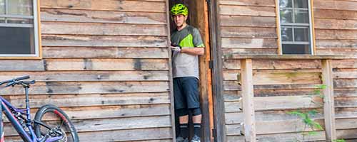 Troy Brosnan in the doorway of the Settlers Hut